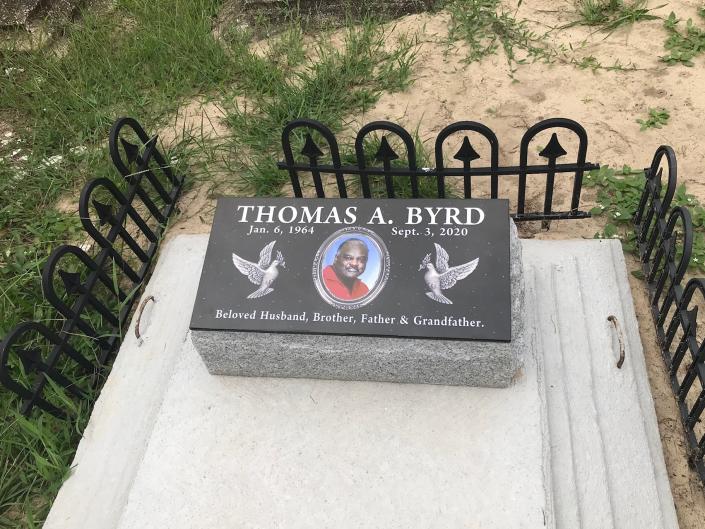 BLACK TILE ON GREY GRANITE WITH ETCHED PICTURE 2 DOVES ON TOP OF VAULT 