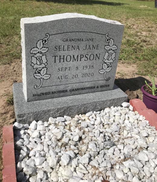 GREY UPRIGHT WITH FLOWERS AND ROCKS/COPING OR BRICK